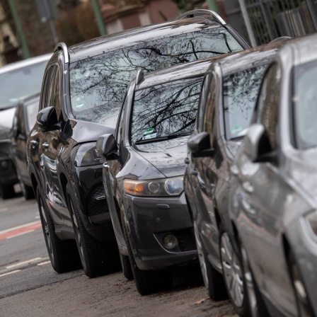 Ein SUV parkt in einer Reihe mit anderen Autos und steht sichtbar am weitesten in die Fahrbahn hinein.