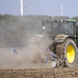 Ein Traktor bearbeitet einen Acker, der durch lange Trockenheit im Frühjahr 2025 völlig ausgetrocknet ist. 