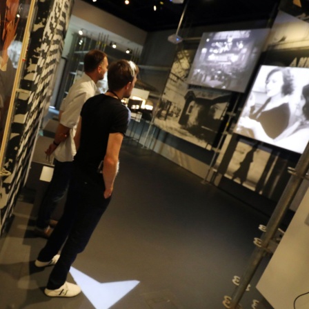 Zwei Männer laufen durch die Ausstellung "Kino der Moderne - Filme in der Weimarer Republik" in der Deutschen Kinemathek in Berlin (Bild: dpa / Wolfgang Kumm)