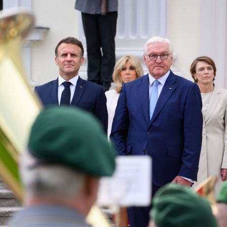 Bundespräsident Frank-Walter Steinmeier und seine Frau Elke Büdenbender begrüßen Emmanuel Macron, Präsident von Frankreich, und seine Frau Brigitte Macron mit militärischen Ehren vor dem Schloss Bellevue.