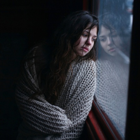 Eine Frau schaut traurig aus einem Fenster: Soldaten vergewaltigen Frauen und Mädchen, ein besonders schreckliches Kriegsphänomen. Sexualisierte Gewalt gilt als effiziente Waffe. Auch für den Krieg in der Ukraine sind solche Fälle belegt.