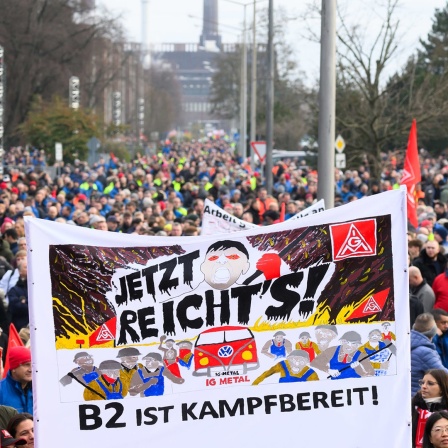 Beschäftigte von VW nehmen an einem Warnstreik vor dem Stammwerk in Wolfsburg teil.