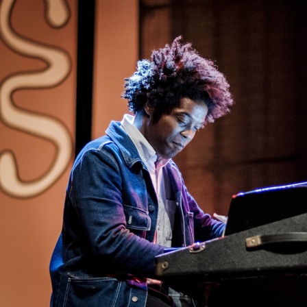 Der Musiker Christophe Chassol sitzt auf einer Bühne an einem E-Piano