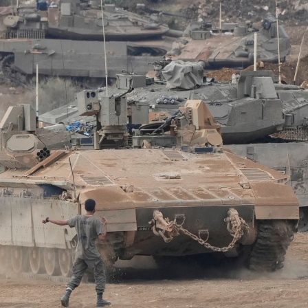 Israelische gepanzerte Mannschaftstransportwagen und Panzer manövrieren in einem Bereitstellungsraum im Norden Israels nahe der israelisch-libanesischen Grenze.