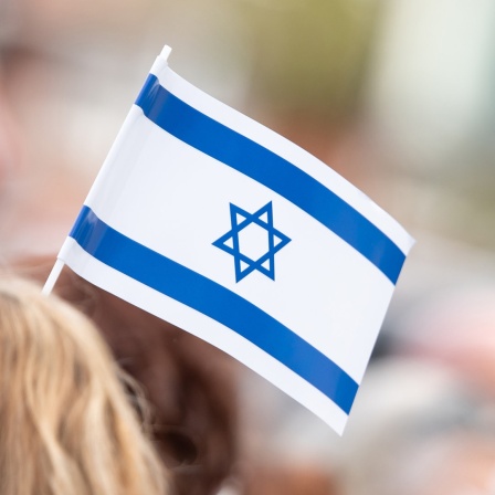 Teilnehmer einerr Demonstration tragen Israel-Fahnen.