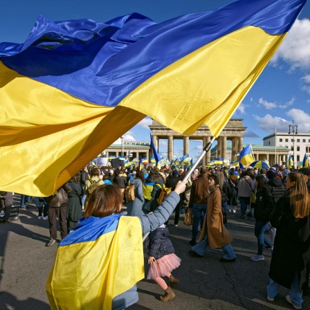 Pro-ukrainische Demonstration am 24.2.2024 in Berlin mit blau-gelben Flaggen vor dem Brandenburger Tor