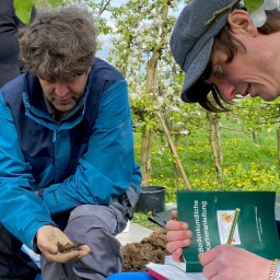 Professor Lars Kutzbach (M.) vom Institut für Bodenkunde der Universität Hamburg untersucht mit Studenten Böden zwischen Apfelbäumen in Klein Hove im Alten Land.
