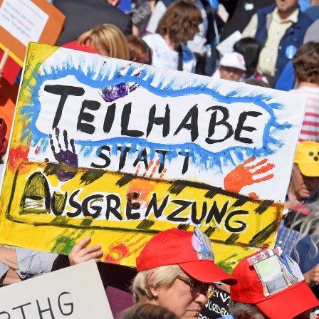 Demo mit Plakat "Teilhabe statt Ausgrenzung"