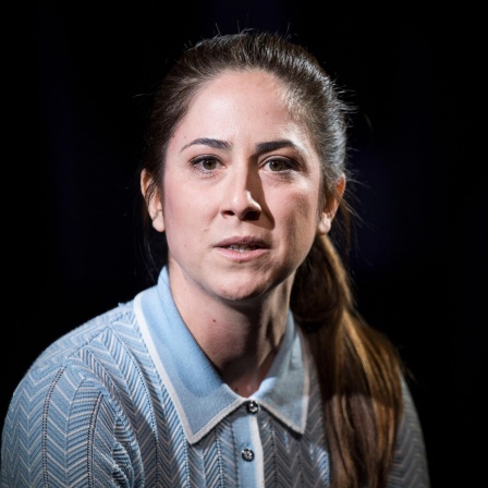 Schauspielerin Vidina Popov spielt bei einer Fotoprobe zum Stück Fremd von Michel Friedman unter Regie von Lena Brasch im Studio R des Maxim Gorki Theater in Berlin. Der Hintergrund ist schwarz.