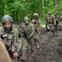 Ukrainische Soldaten gehen in der Nähe eines kürzlich zurückeroberten Dorfes nördlich von Charkiw in der Ostukraine durch den Wald.