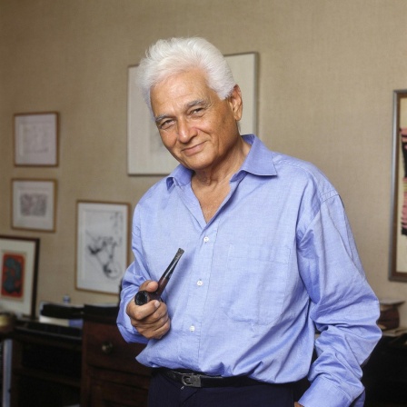 Der Philosoph Jacques Derrida (1930−2004) im blauen Hemd und einer Pfeife in der Hand.