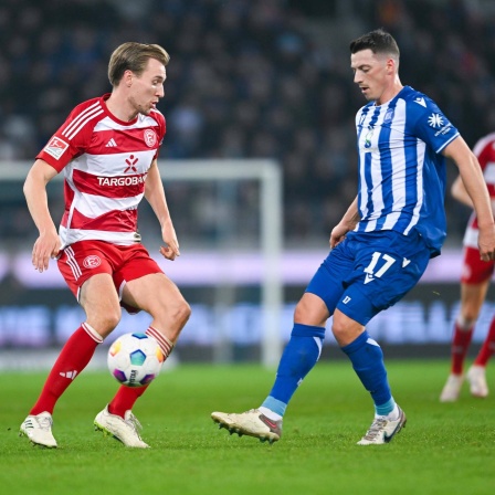 Vincent Vermeij (Fortuna Düsseldorf) und Nicolai Rapp (Karlsruher SC) stehen um den Ball