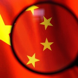 Flag of China seen displayed on a computer screen through a magnifying glass