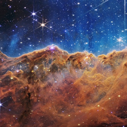 Was an einem Mondabend wie schroffe Berge aussieht, ist in Wirklichkeit der Rand einer nahegelegenen, jungen Sternentstehungsregion NGC 3324 im Carina-Nebel. Dieses Bild wurde von der Nahinfrarotkamera (NIRCam) des James-Webb-Weltraumteleskops der NASA im Infrarotlicht aufgenommen und enthüllt bisher verborgene Bereiche der Sternentstehung.