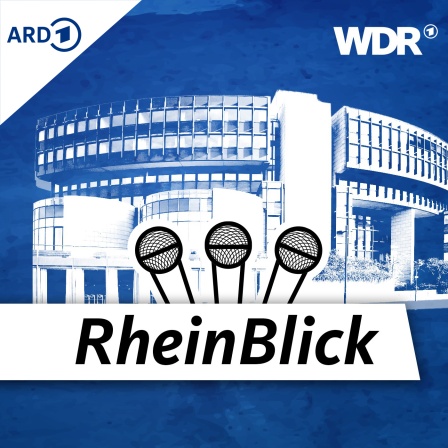 Hendrik Wüst auf einem Termin gegen Mobbin, rechts von ihm steht ein Organisator und ein Maskottchen, das wie ein Monster aussieht