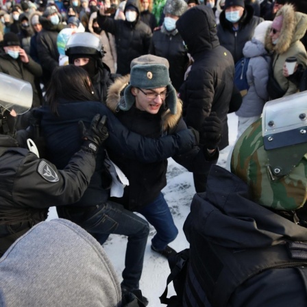 NOVOSIBIRSK, RUSSIA - JANUARY 23, 2021: Riot police officers detain a participant in an unauthorized rally in support of Russian opposition activist Alexei Navalny near Lenina Square. Navalny's supporters started calling for protests after his arrest was