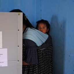 Mit ihrem Kleinkind auf dem Rücken gibt eine Frau ihre Stimme beim ersten Wahlgang der indischen Parlamentswahl im Dorf Chedema im nordöstlichen indischen Bundesstaat Nagaland ab. 