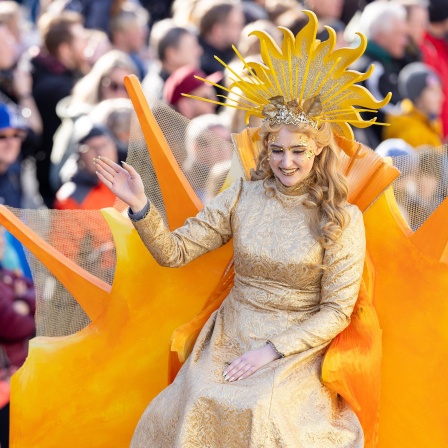 Frau Sunna grüßt beim Festumzug zum  Sommergewinn die Zuschauer.