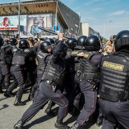 Polizisten zerschlagen eine Demonstration