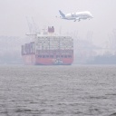 Ein Airbus-Transportflugzeug vom Typ
Beluga fliegt im Landeanflug auf das Werksgelände in
Finkenwerder über ein riesiges Containerschiff der
Reederei Hamburg Süd auf der Elbe