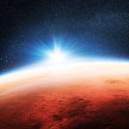 Illustration in kräftigen Farben des vom All aus gesehenen Planeten Mars, hinter dessen Horizont die Sonne aufgeht