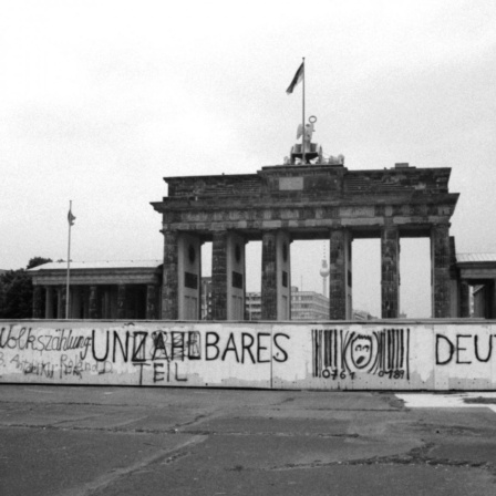 Historisches Foto von 1987: An der Mauer vor dem Brandenburger Tor in Berlin ein Graffiti "Unzählbares Deutschland". 