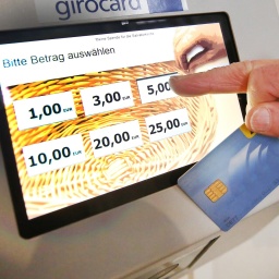 An einem digitalen Spendenautomat spendet 2018 eine Frau in der Salvatorkirche per EC-Karte.