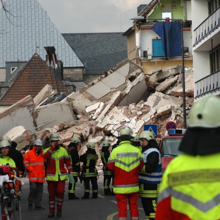 Feuerwehr und Rettungskräfte stehen am eingestürzten historischen Stadtarchiv in Köln.