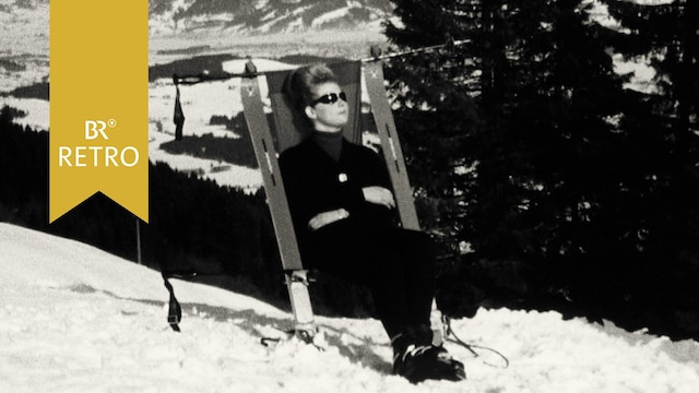 Skifahrerin sonnt sich im improvisierten Liegestuhl aus Skiern | Bild: BR Archiv