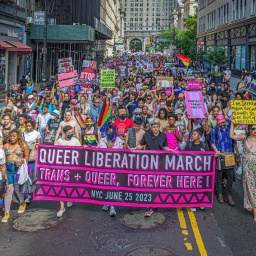 Eine Demonstration für queeres Leben im Juni 2023 in New York City. Die Protestierenden tragen Transparente und viele Farben der queeren Bewegung.