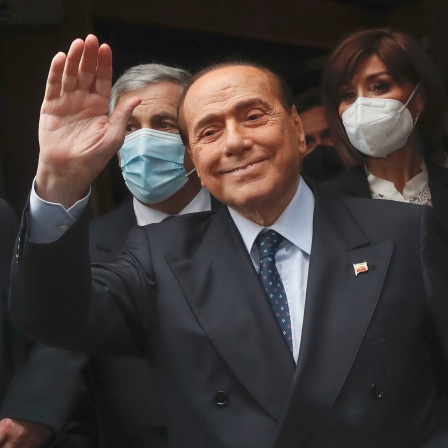 Silvio Berlusconi winkt zu Reportern