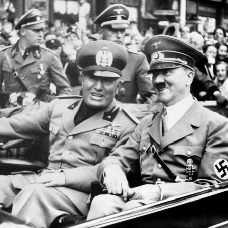Adolf Hitler und der italienische Diktator Benito Mussolini (links) gut gelaunt im offenen Wagen am 29. September 1938 in München anlässlich der Konferenz zur tschechischen Krise. Hitler hatte Mussolini am Bahnhof abgeholt und zusammen fuhren sie im Auto weiter zum Ort der Münchner Konferenz, dem &#034;Braunen Haus&#034;.