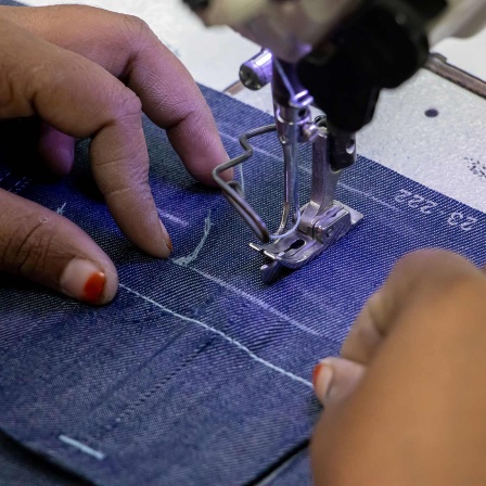 Ein Arbeiterin in einer Fabrik in Bangladesch näht ein Kleidungsstück zusammen. 