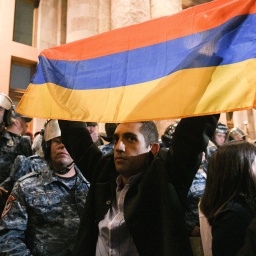 A protester holds the Armenian flag outside the Armenian Government Building. On 19 September 2023, Azerbaijan s Defence Ministry announced to begin to take local counter-terrorist measures in Nagorno-Karabakh to restore constitutional order.