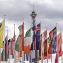 Flaggen verschiedener Länder vor dem Eingang zur Messe, im Hintergrund der Funkturm. 