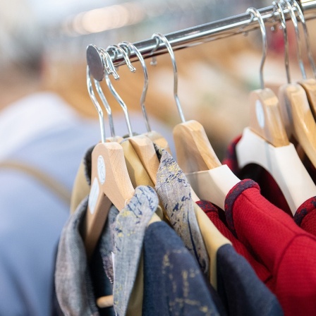 Nachhaltig produzierte Kleidung hängt an Kleiderbügeln