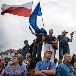 Menschen schwenkendie polnische und europäische Flagge während einer von Donald Tusk organisierten pro-EU Kundgebung © picture alliance / Sipa USA | SOPA Images