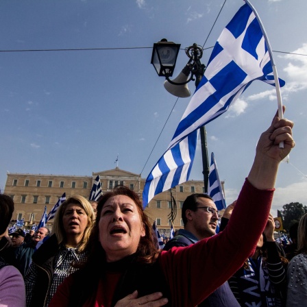 Greece: Demonstrate against the use of Macedonia A woman is seen singing the Greek Anthem during the demonstration