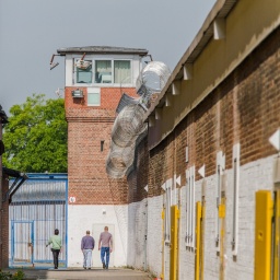 Das Beitragsbild des Dok5 "Ersatzfreiheitsstrafe - Streit um den Schuldturm für Arme" zeigt zwei Gefängnisinsassen auf dem Anstaltsgelände der Justizvollzugsanstalt Werl.