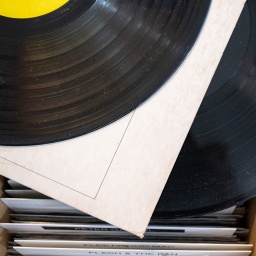  Zwei Schallplatten liegt auf einer Box mit weiteren Tonträgern.