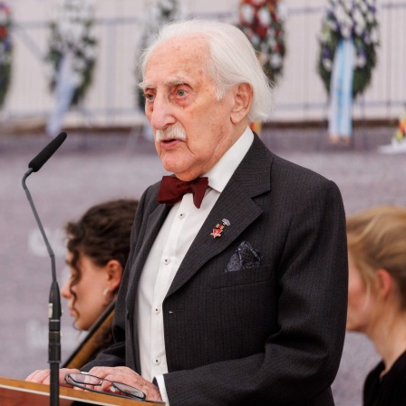 Der Holocaust-Überlebende Leon Weintraub steht beim Gedenkakt zum 78. Jahrestag der Befreiung des KZs Flossenbürg an einem Rednerpult.