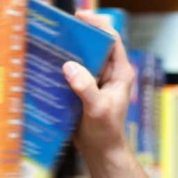 Hand nimmt Buch aus einem Regal