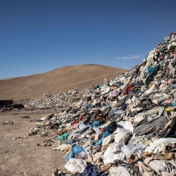 Gebrauchte Kleidungsstücke liegen in einer Müll-Deponie in der Wüste (Bild: picture alliance/dpa/Antonio Cossio)