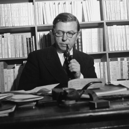 Jean-Paul Sartre mit Pfeife im Arbeitszimmer