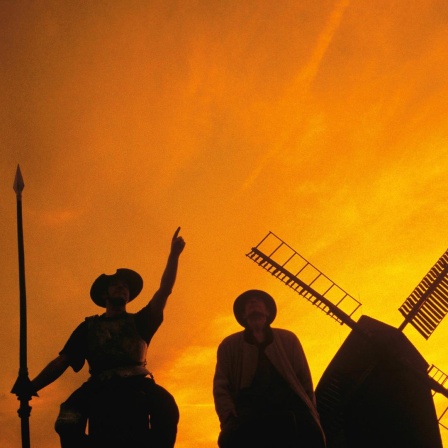 Don Quijote mit Sancho Pansa vor einer Windmühle.