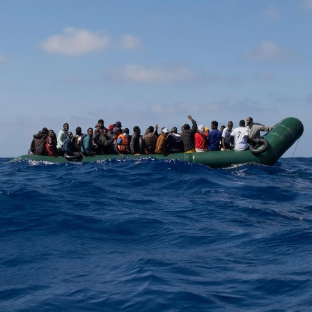 Ein Schlauchboot mit Flüchtlingen treibt auf dem Mittelmeer. 