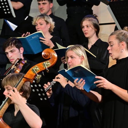 Sängerinnen und Sänger des Sächsischen Jugendchors singen und werden von einer Oboistin, einen Kontrabassspieler und einem Violinisten begleitet.