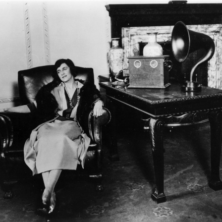 Woman listening to a Marconi speaker.