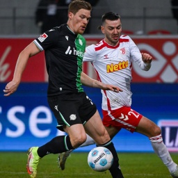 Marcel Halstenberg von Hannover (l) und Sargis Adamyan von Regensburg kämpfen um den Ball.