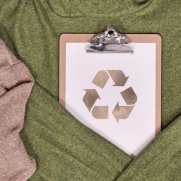 Das Recycling-Symbol ist auf Pullovern zu sehen.